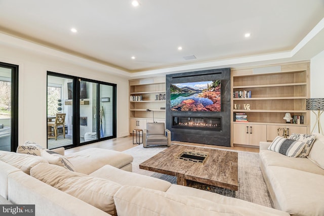 1544 Forest Villa Ln, Mclean, VA 22101 - living area with a fireplace, light wood-style floors, a tray ceiling, recessed lighting, and built in features
