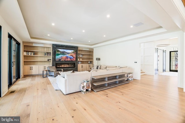 1544 Forest Villa Ln, Mclean, VA 22101 - living area with a tray ceiling, light wood finished floors, a glass covered fireplace, recessed lighting, and stairs