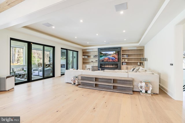 1544 Forest Villa Ln, Mclean, VA 22101 - living area featuring a tray ceiling, wood finished floors, a glass covered fireplace, and built in features