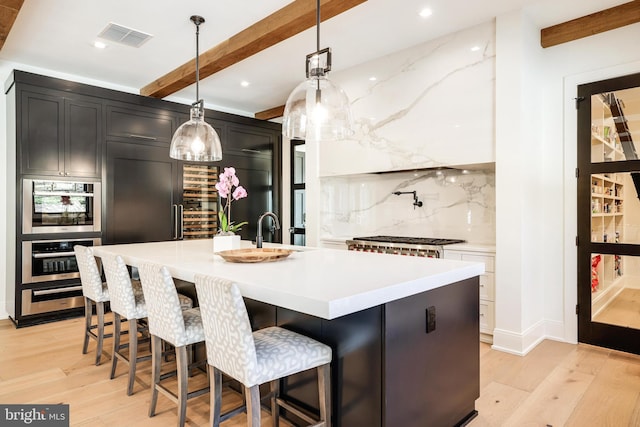 1544 Forest Villa Ln, Mclean, VA 22101 - kitchen with decorative backsplash, light wood finished floors, beamed ceiling, light countertops, and an island with sink