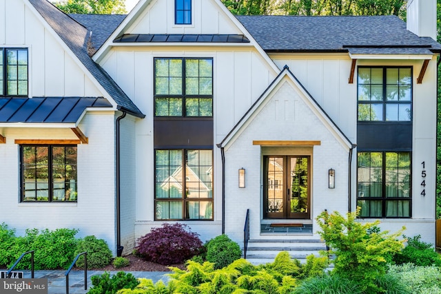 1544 Forest Villa Ln, Mclean, VA 22101 - view of front of property with roof with shingles, brick siding, board and batten siding, and a standing seam roof