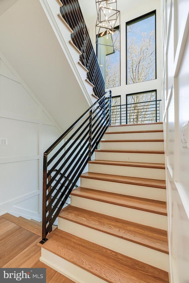1544 Forest Villa Ln, Mclean, VA 22101 - staircase featuring wood finished floors and a chandelier