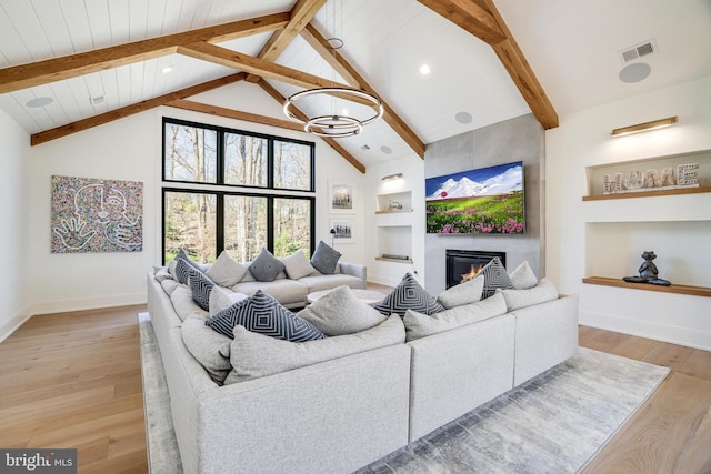 1544 Forest Villa Ln, Mclean, VA 22101 - living room with built in shelves, baseboards, beam ceiling, light wood-style floors, and a large fireplace