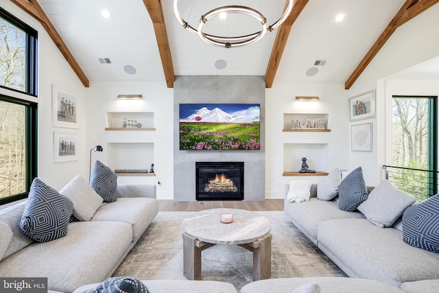 1544 Forest Villa Ln, Mclean, VA 22101 - living room featuring wood finished floors, a chandelier, built in features, a large fireplace, and baseboards