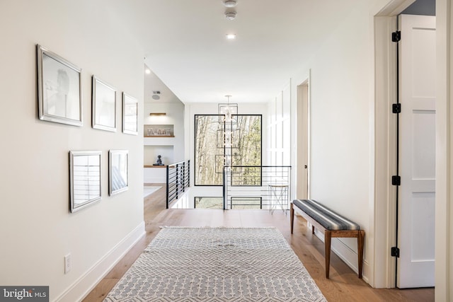 1544 Forest Villa Ln, Mclean, VA 22101 - corridor featuring light wood finished floors, baseboards, a chandelier, built in shelves, and an upstairs landing