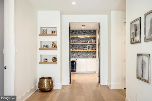 1544 Forest Villa Ln, Mclean, VA 22101 - corridor with light wood finished floors, beverage cooler, built in features, and baseboards