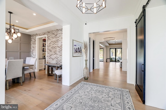1544 Forest Villa Ln, Mclean, VA 22101 - entryway featuring a chandelier, light wood-style flooring, a barn door, and ornamental molding