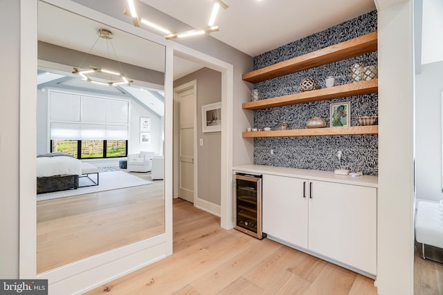 1544 Forest Villa Ln, Mclean, VA 22101 - indoor bar featuring beverage cooler, backsplash, light wood-style floors, and a chandelier