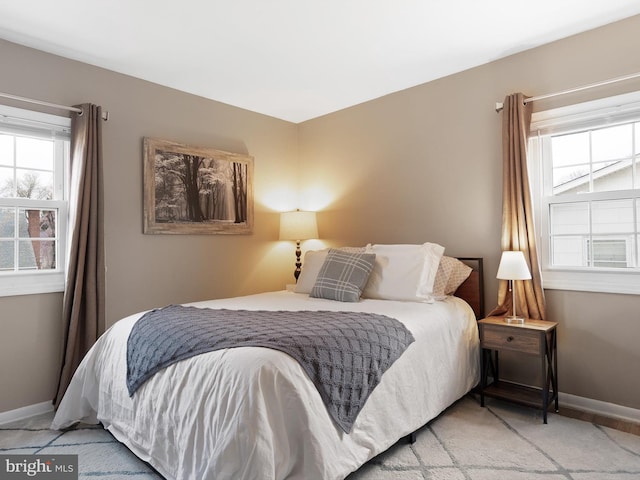 bedroom with baseboards and carpet floors