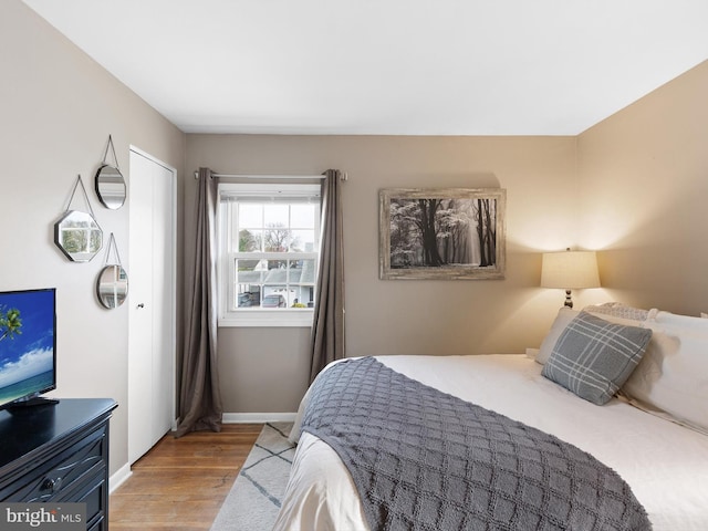 bedroom featuring baseboards and wood finished floors