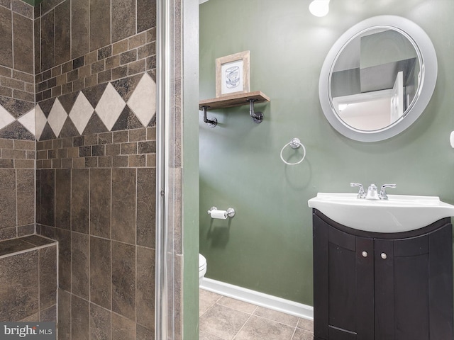 full bathroom featuring baseboards, toilet, vanity, and a shower stall