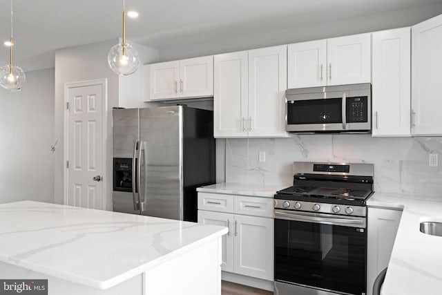 1404 S Patton St, Philadelphia, PA 19146 - kitchen featuring white cabinetry, decorative backsplash, and appliances with stainless steel finishes