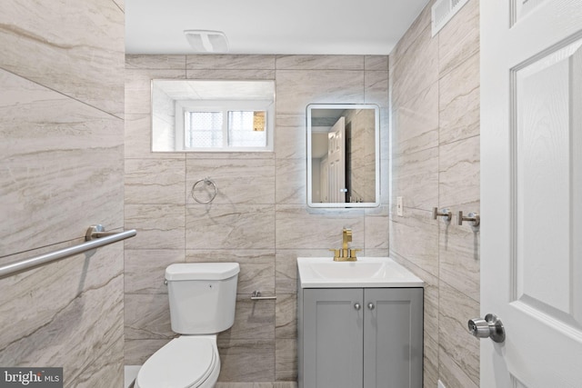 1404 S Patton St, Philadelphia, PA 19146 - bathroom featuring tile walls, toilet, and vanity