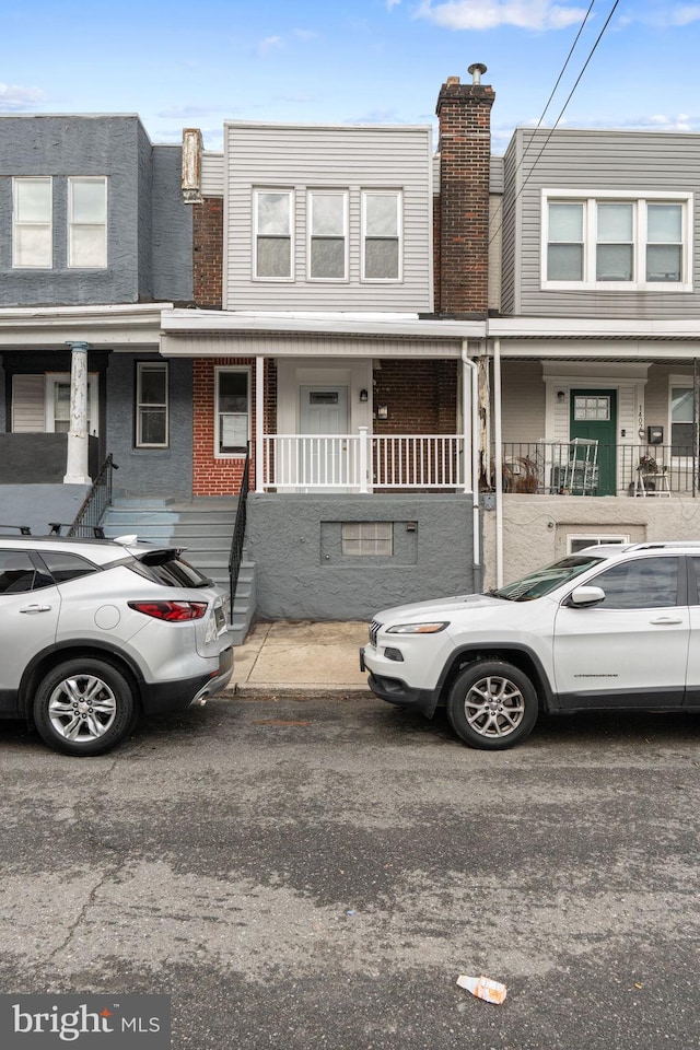 1404 S Patton St, Philadelphia, PA 19146 - view of property featuring covered porch and brick siding