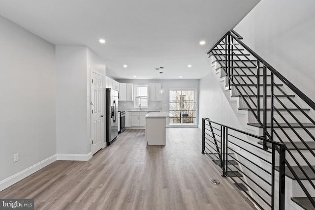 1404 S Patton St, Philadelphia, PA 19146 - kitchen featuring white cabinetry, light countertops, light wood-style floors, and stainless steel refrigerator with ice dispenser