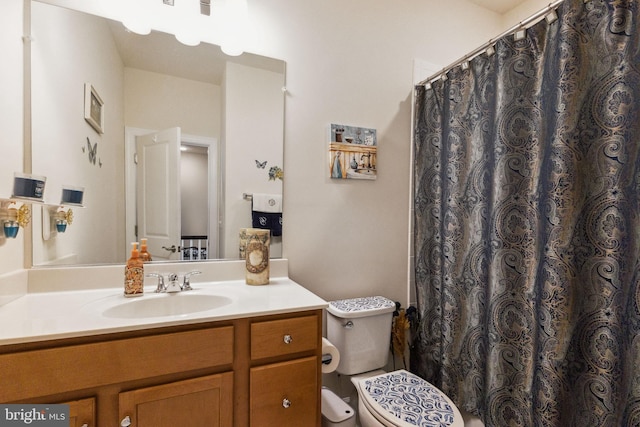 bathroom featuring toilet, vanity, and a shower with shower curtain