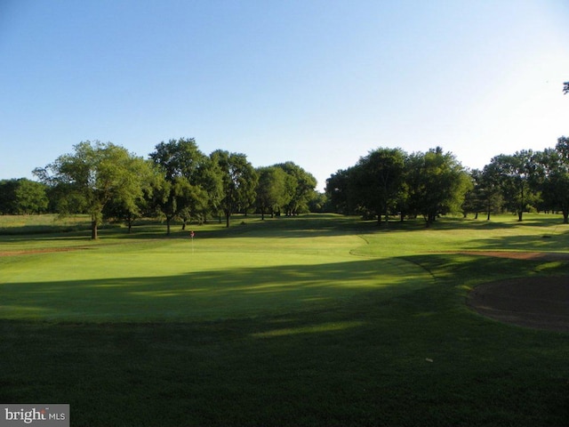 surrounding community featuring a yard and golf course view