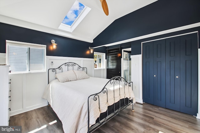 bedroom featuring lofted ceiling with skylight and wood finished floors