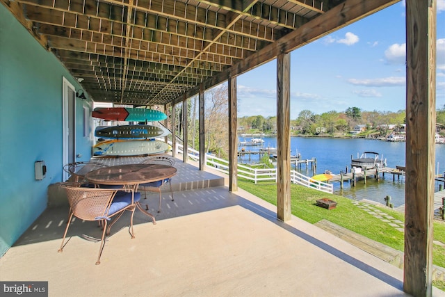 view of patio / terrace featuring a water view and a dock