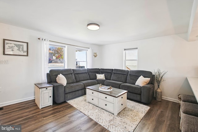 living area featuring dark wood-style floors and baseboards