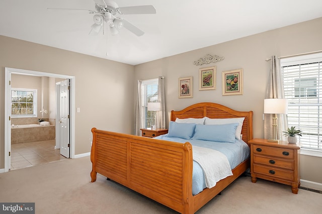 304 S Heron Gull Ct, Ocean City, MD 21842 - bedroom with ensuite bathroom, ceiling fan, baseboards, and light colored carpet