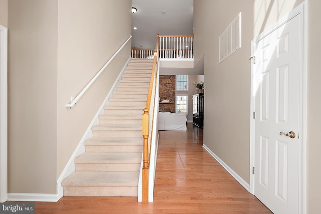 304 S Heron Gull Ct, Ocean City, MD 21842 - stairs with a high ceiling, wood finished floors, baseboards, and visible vents