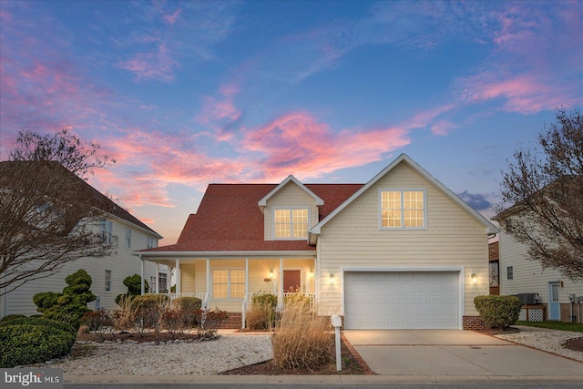 304 S Heron Gull Ct, Ocean City, MD 21842 - traditional home featuring covered porch, a garage, and concrete driveway