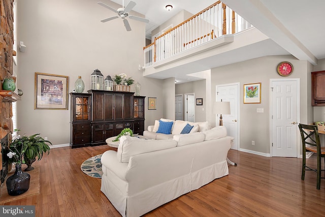 304 S Heron Gull Ct, Ocean City, MD 21842 - living area featuring a towering ceiling, baseboards, wood finished floors, and ceiling fan