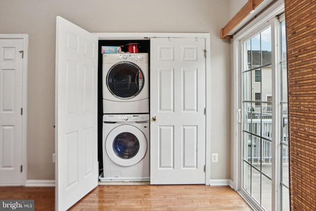 25149 Shultz Ter, Chantilly, VA 20152 - laundry room with stacked washer / dryer, light wood-style flooring, and baseboards