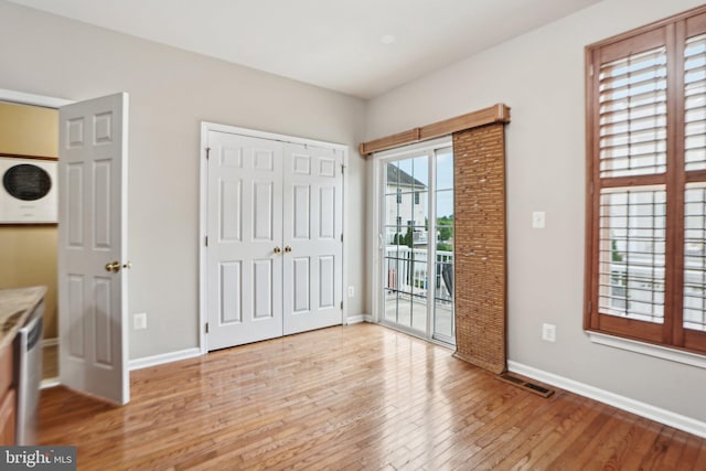 25149 Shultz Ter, Chantilly, VA 20152 - unfurnished bedroom featuring access to outside, light wood-type flooring, baseboards, and a closet