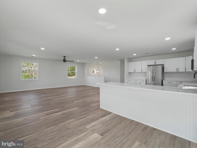 kitchen featuring recessed lighting, freestanding refrigerator, and open floor plan