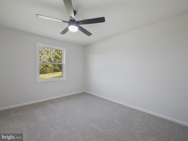 spare room featuring carpet flooring, a ceiling fan, and baseboards