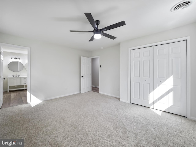 unfurnished bedroom with carpet floors, visible vents, and baseboards