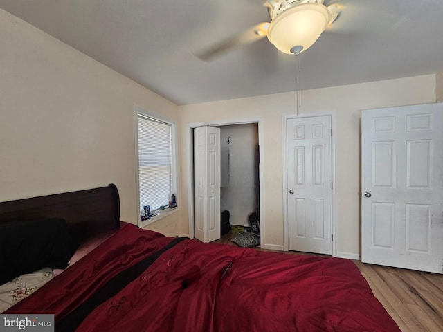bedroom featuring baseboards, a closet, ceiling fan, and wood finished floors