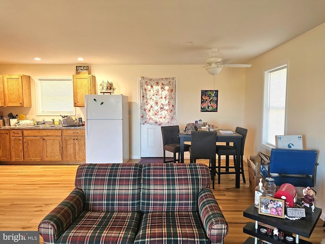 living area with ceiling fan, recessed lighting, and light wood-style floors