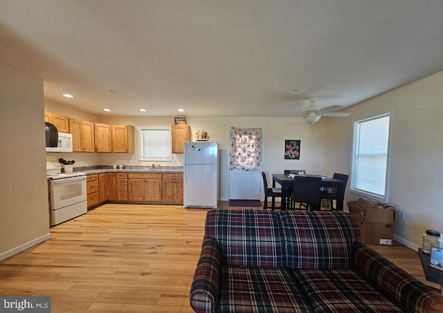 kitchen with a ceiling fan, light wood-style flooring, baseboards, white appliances, and recessed lighting
