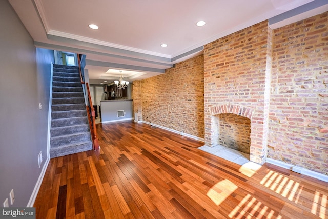 6 N Luzerne Ave, Baltimore, MD 21224 - unfurnished living room with baseboards, wood-type flooring, stairs, a chandelier, and recessed lighting