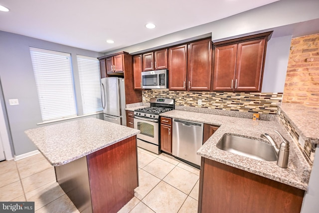 6 N Luzerne Ave, Baltimore, MD 21224 - kitchen with stainless steel appliances, a sink, light tile patterned floors, decorative backsplash, and light stone countertops
