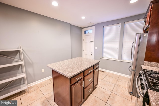 6 N Luzerne Ave, Baltimore, MD 21224 - kitchen with stainless steel appliances, baseboards, recessed lighting, light tile patterned floors, and light stone countertops