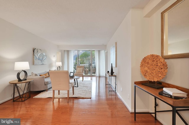 living area with light wood finished floors and baseboards