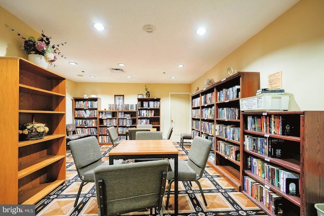 office space with recessed lighting, visible vents, and bookshelves