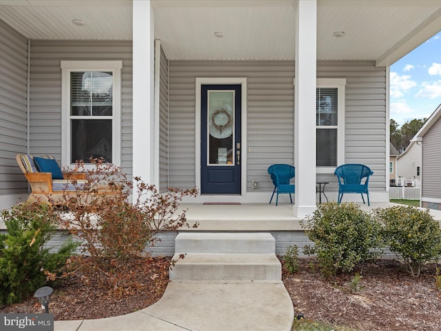 entrance to property featuring a porch