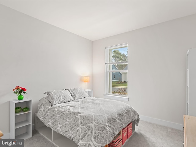 bedroom with carpet flooring and baseboards