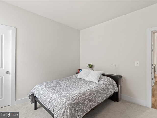 bedroom featuring baseboards and carpet floors