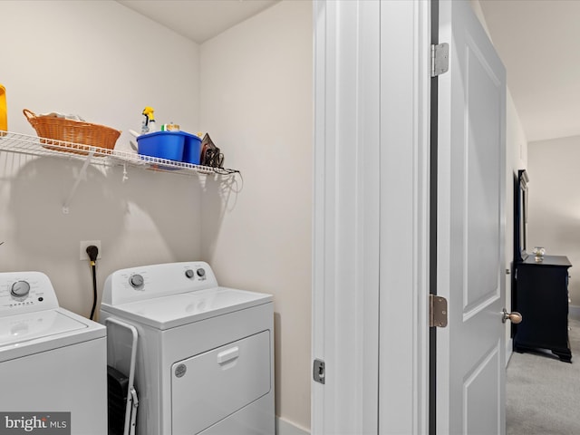 washroom featuring light colored carpet, laundry area, and separate washer and dryer