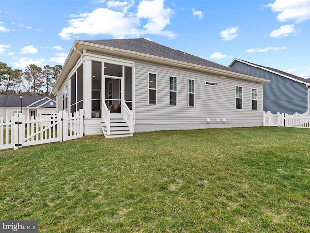 rear view of house with a sunroom, a fenced backyard, a gate, and a lawn