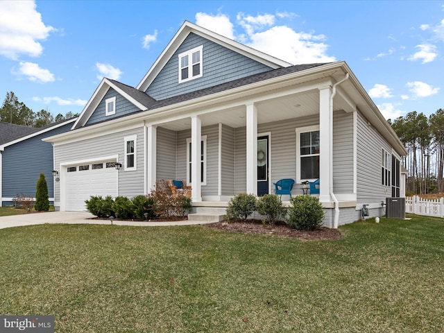 view of front of property featuring covered porch, a front yard, cooling unit, and an attached garage