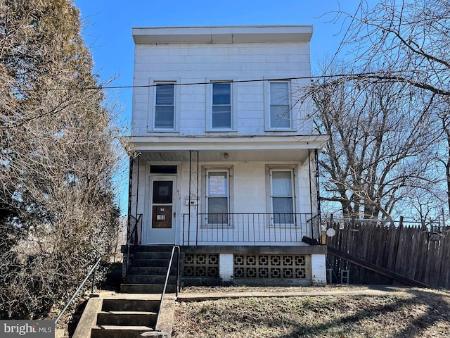 view of front of home with covered porch and fence