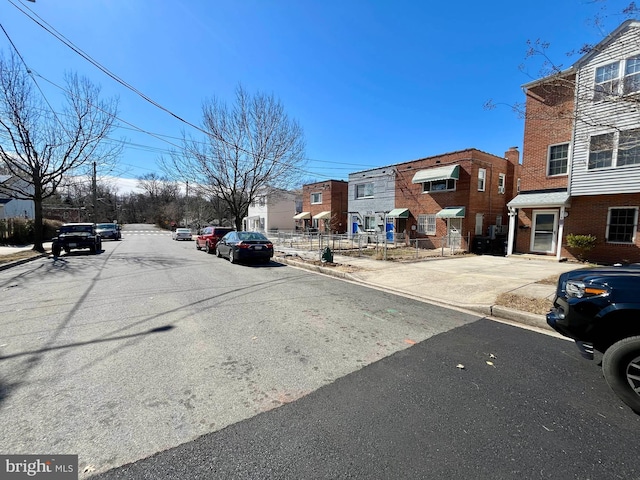 view of street featuring sidewalks, curbs, and a residential view