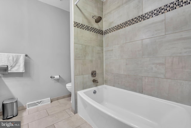 bathroom with visible vents, baseboards, toilet, shower / tub combination, and tile patterned flooring